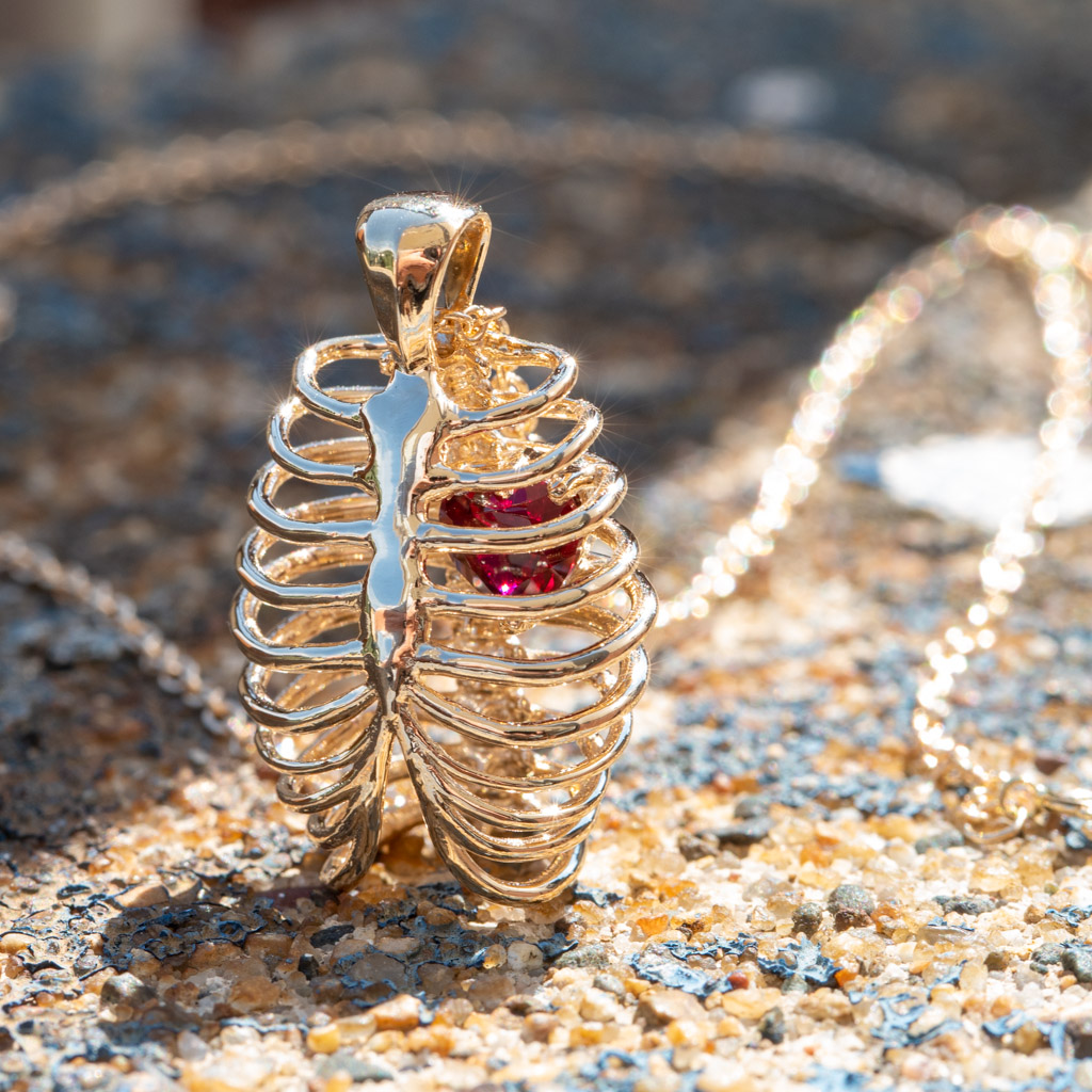 Heart-shaped Ruby in a Yellow Gold Ribcage Pendant