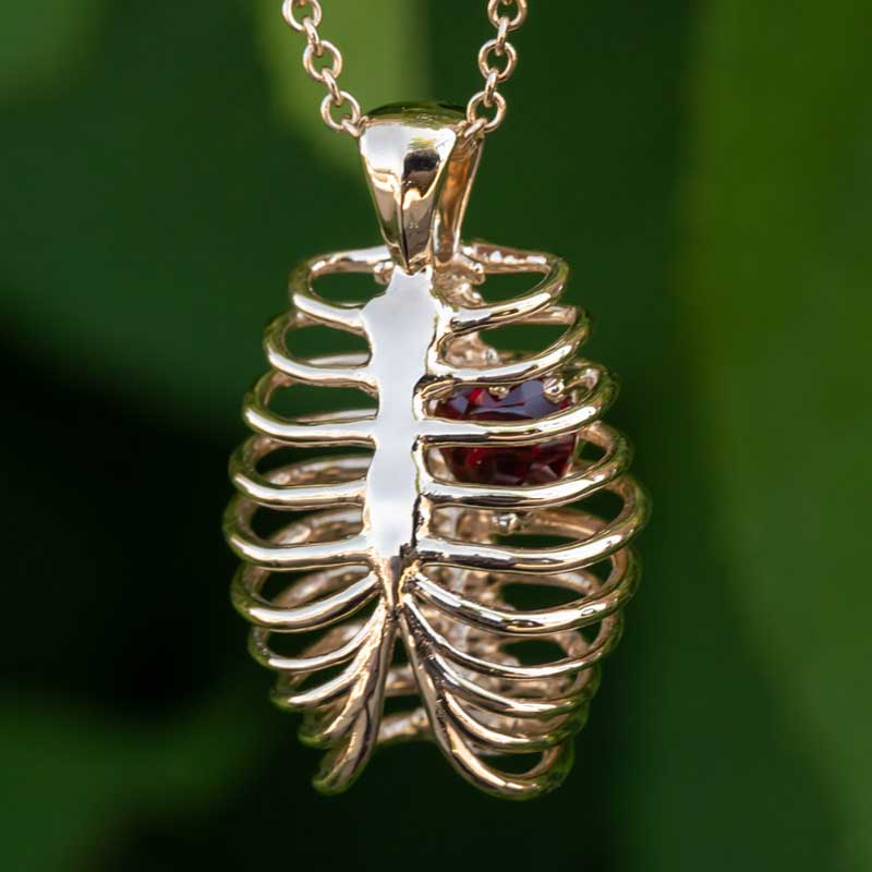 Heart-shaped Ruby in a Yellow Gold Ribcage Pendant